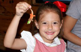 Kids Eat Free at the Causeway Location!! Little Girl Holding Alligator Toy from her Kids Meal