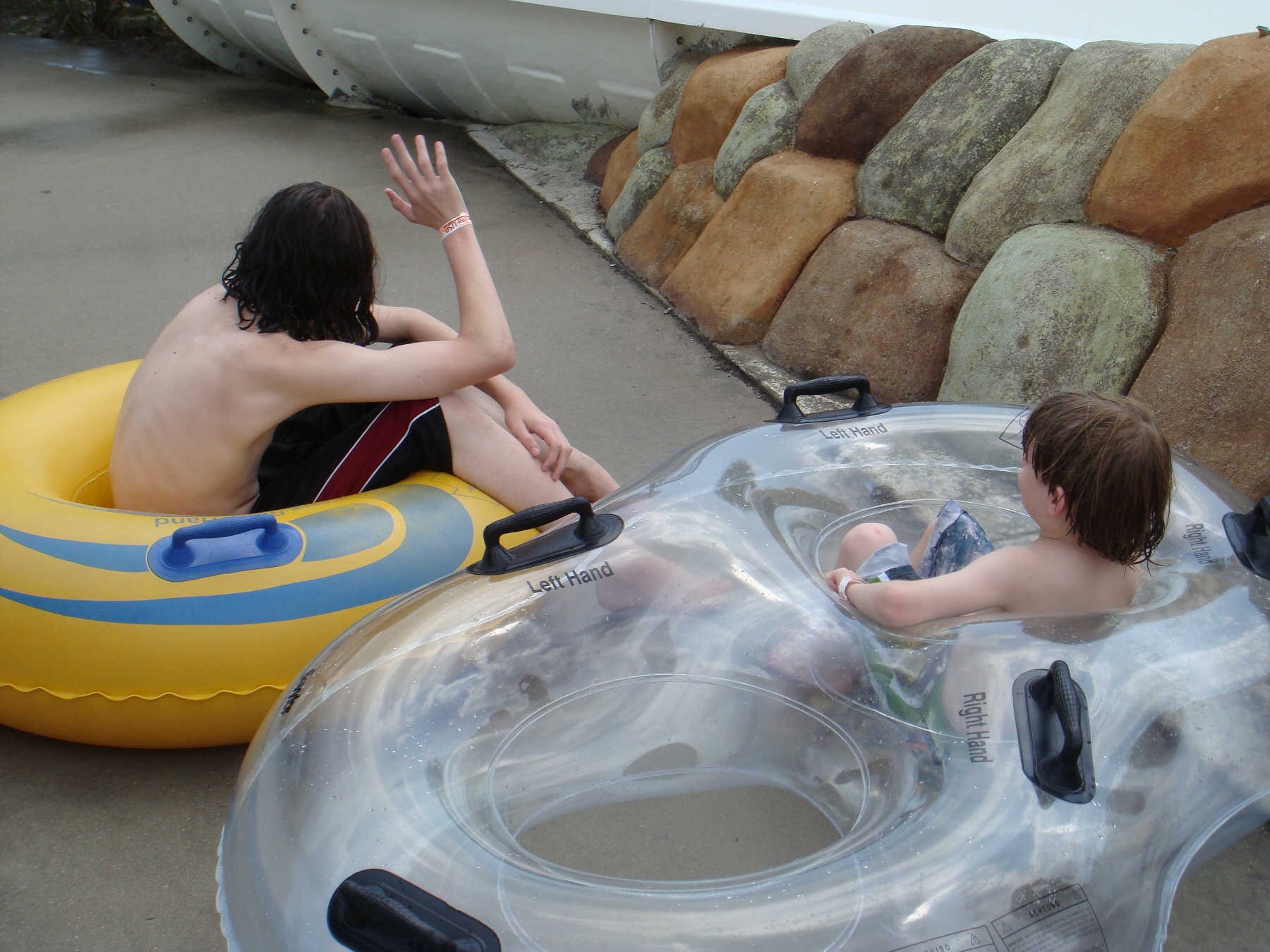 kids sitting in pool floats