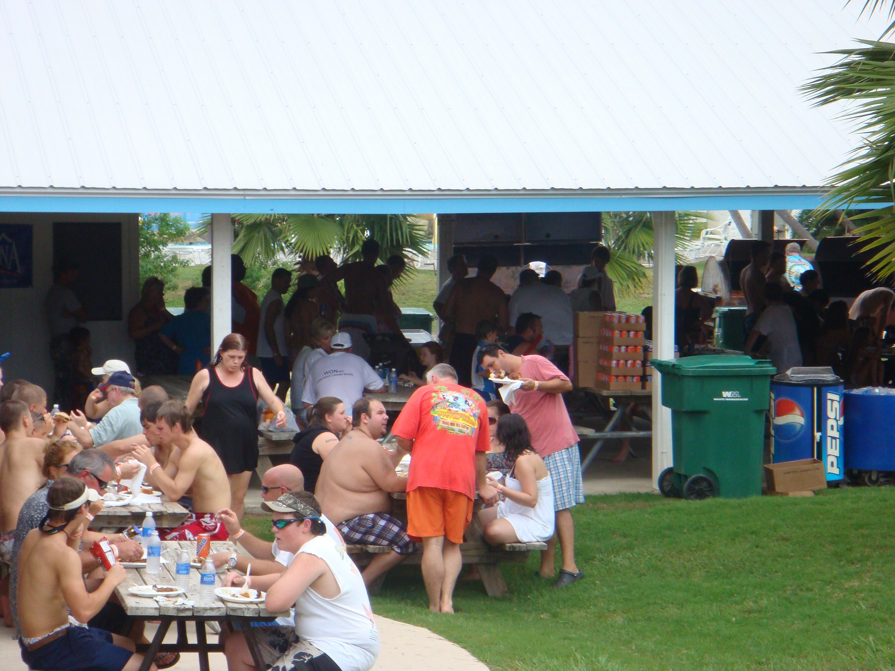 people eating at picnic tables at water park