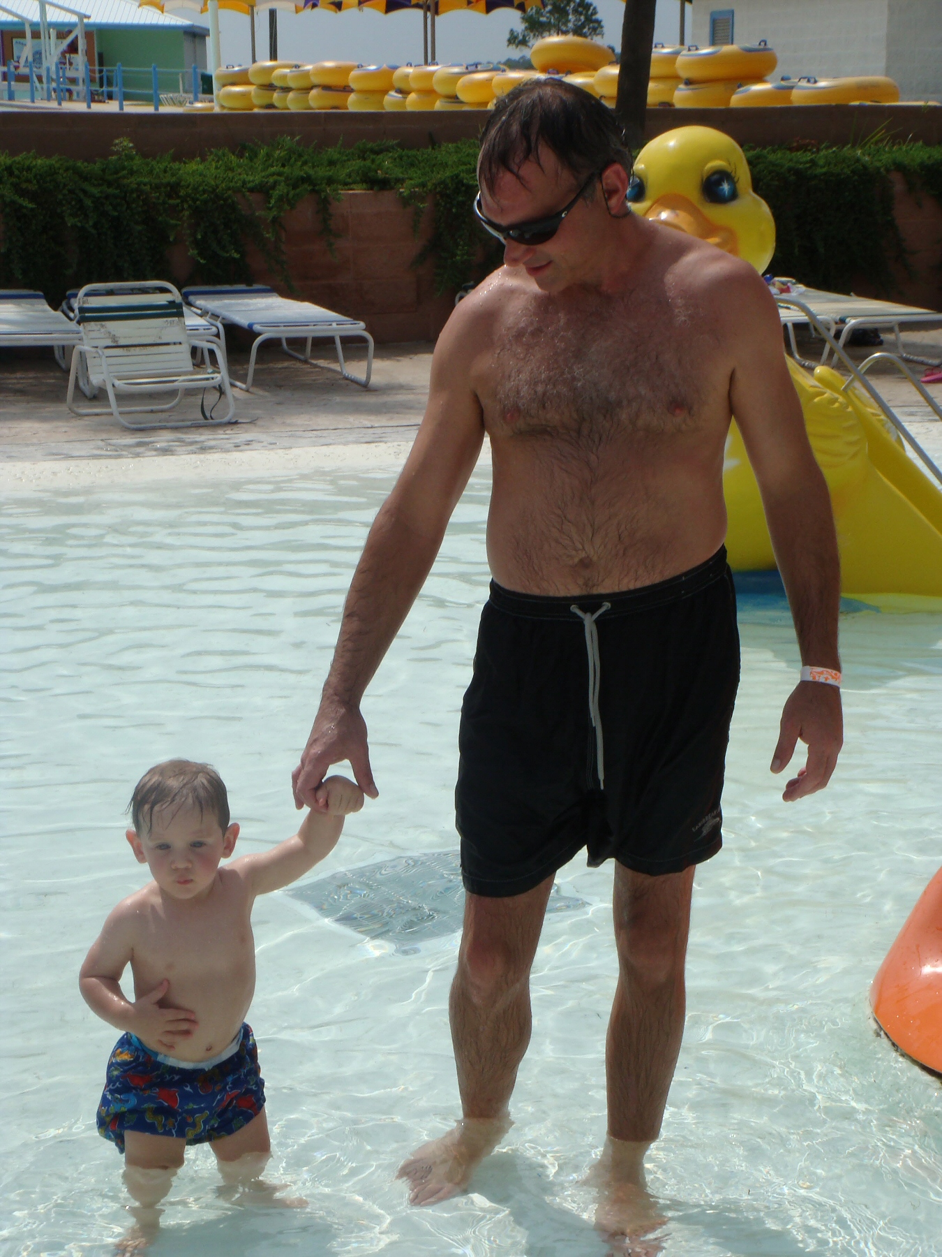man with young boy at water park