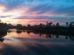 sunset over houses and river