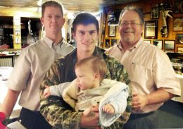 Allen Hastings, general manager; Ronald McCord, employee of the year, holding his son Brantley; and Bud Morris