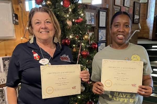 Congratulating Employees of the Year winners at the Gulf Shores Christmas party are pictured from left Lucy Markel front of the house host and Kian Morgan back of the house cook.