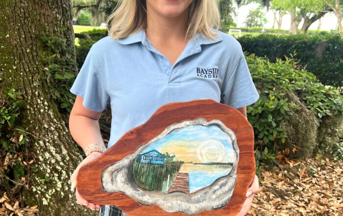 Mary Katherine Crowell shown with her scholarship winning artwork.